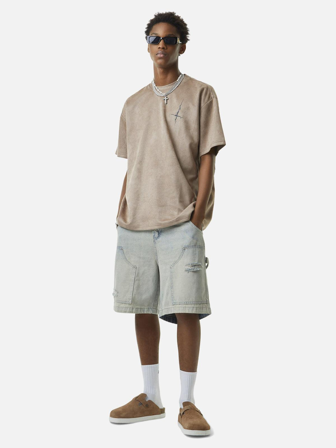 Model wearing TALISHKO retro washed hip-hop shorts, styled with a casual oversized tee and accessories.