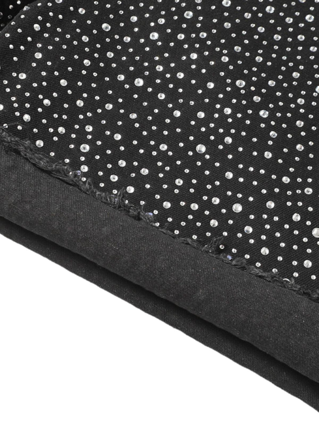 Zoomed-in texture of TALISHKO denim shorts with rhinestones, highlighting intricate design.