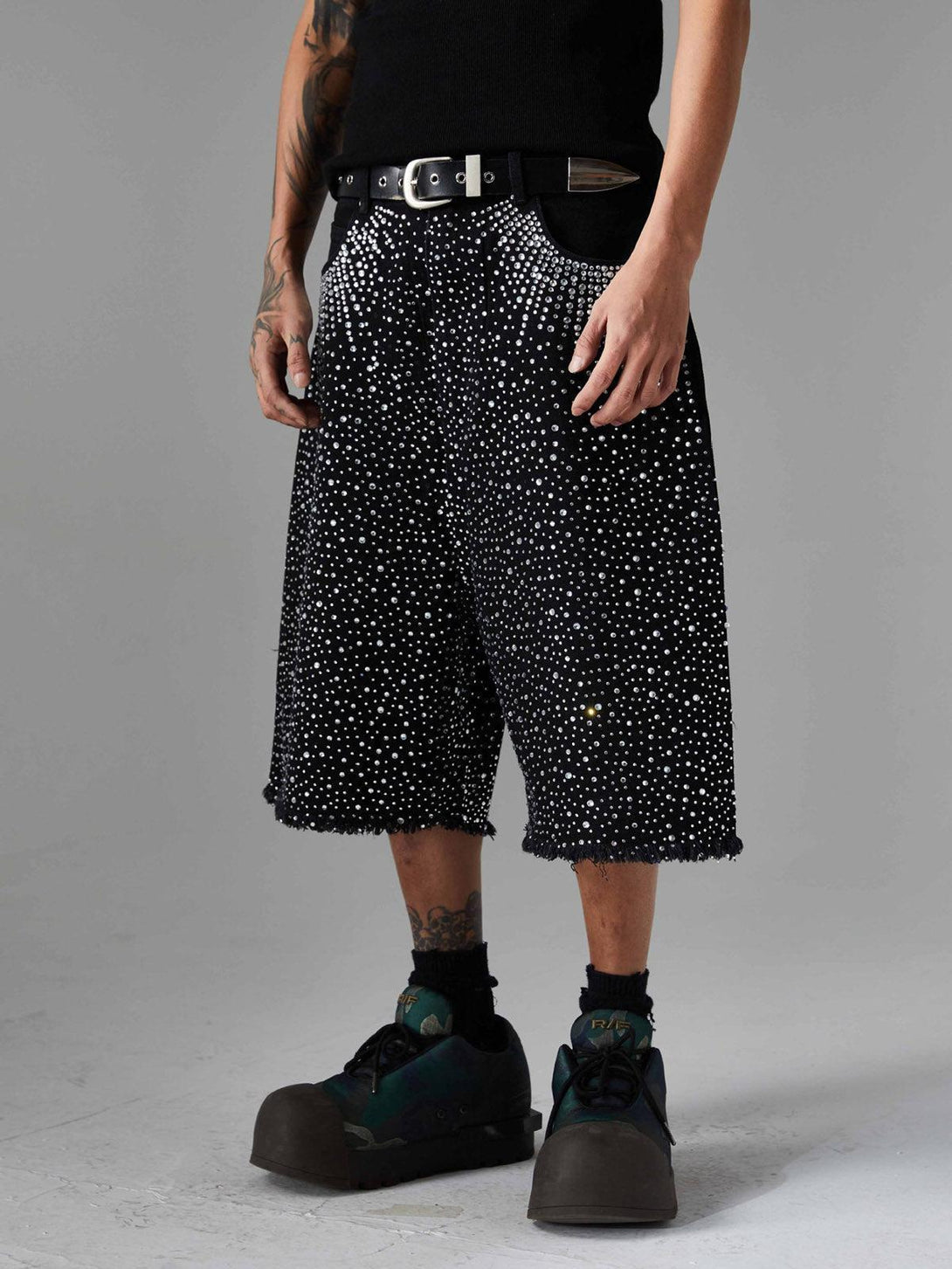 Model wearing TALISHKO rhinestone-studded denim shorts with raw edges, perfect for a retro vibe.