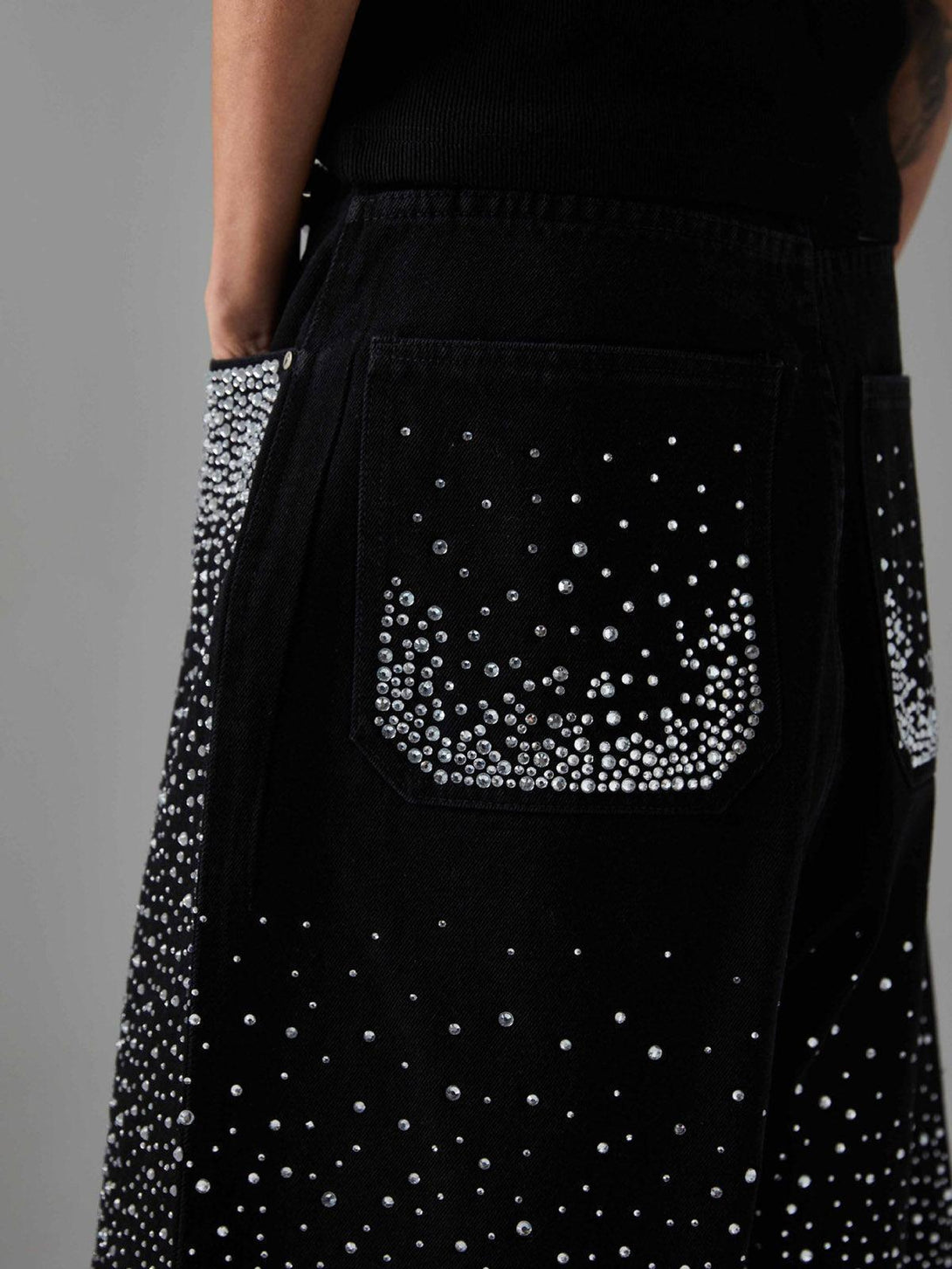 A close-up of TALISHKO denim shorts showcasing rhinestone embellishments and raw edges.