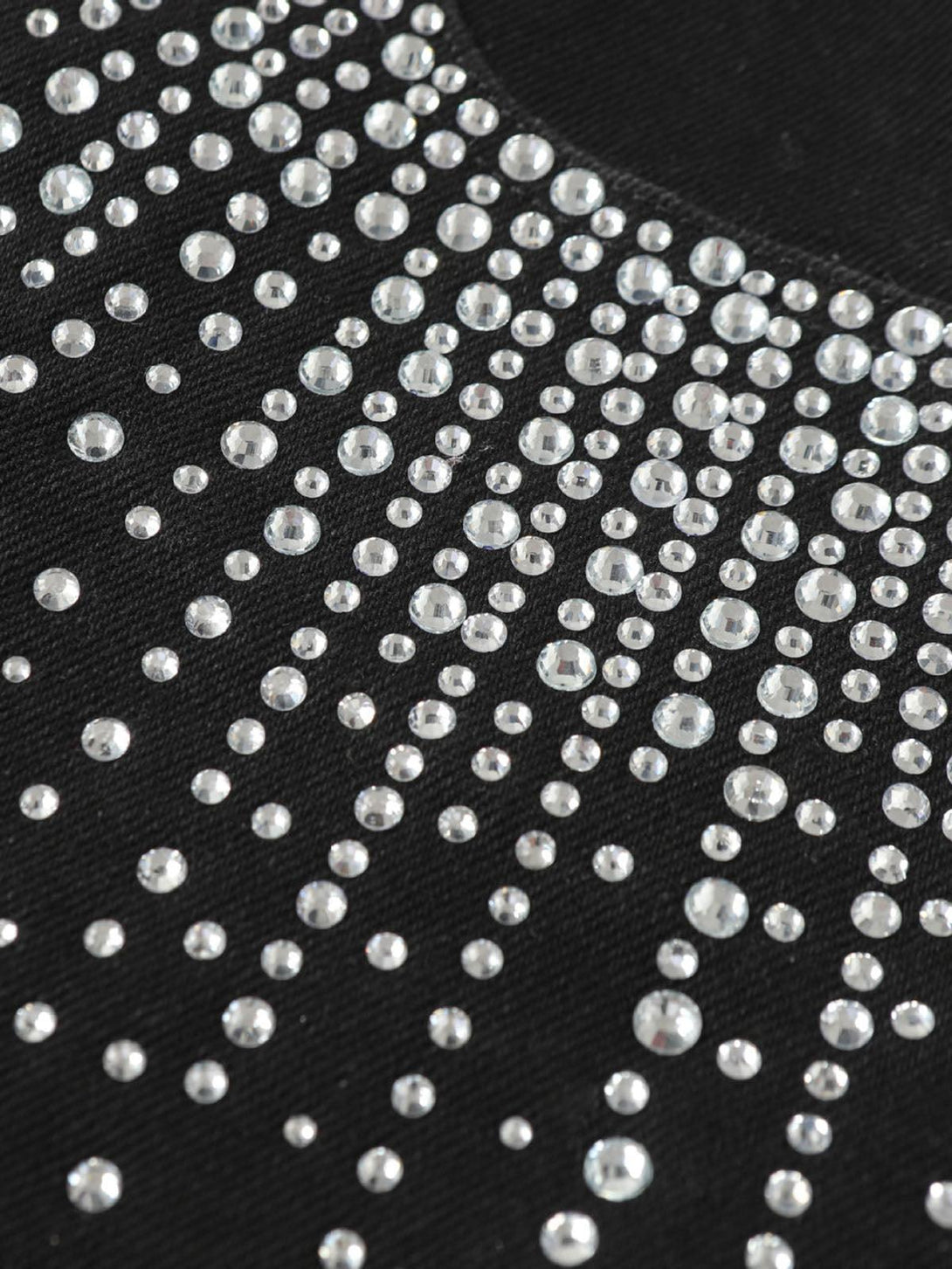 Sparkling rhinestones adorn TALISHKO denim shorts, showcasing intricate detailing.