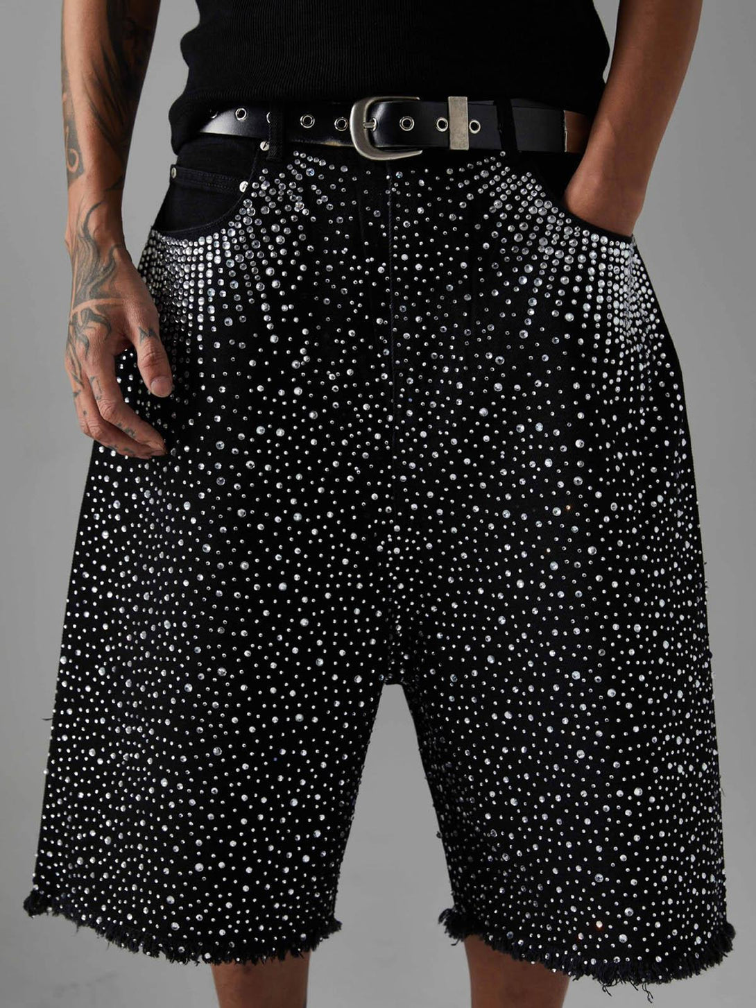 TALISHKO denim shorts with sparkling rhinestones and raw edges, offering a retro flair.