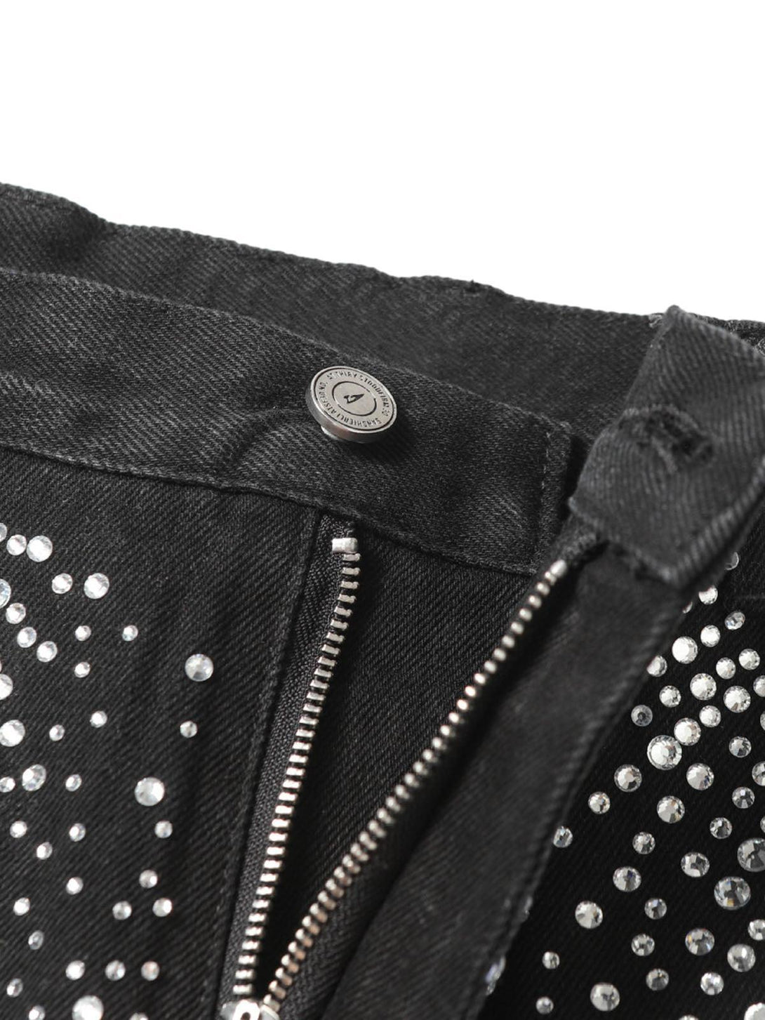 TALISHKO denim shorts detail with rhinestone embellishments and raw edges, offering a chic touch.