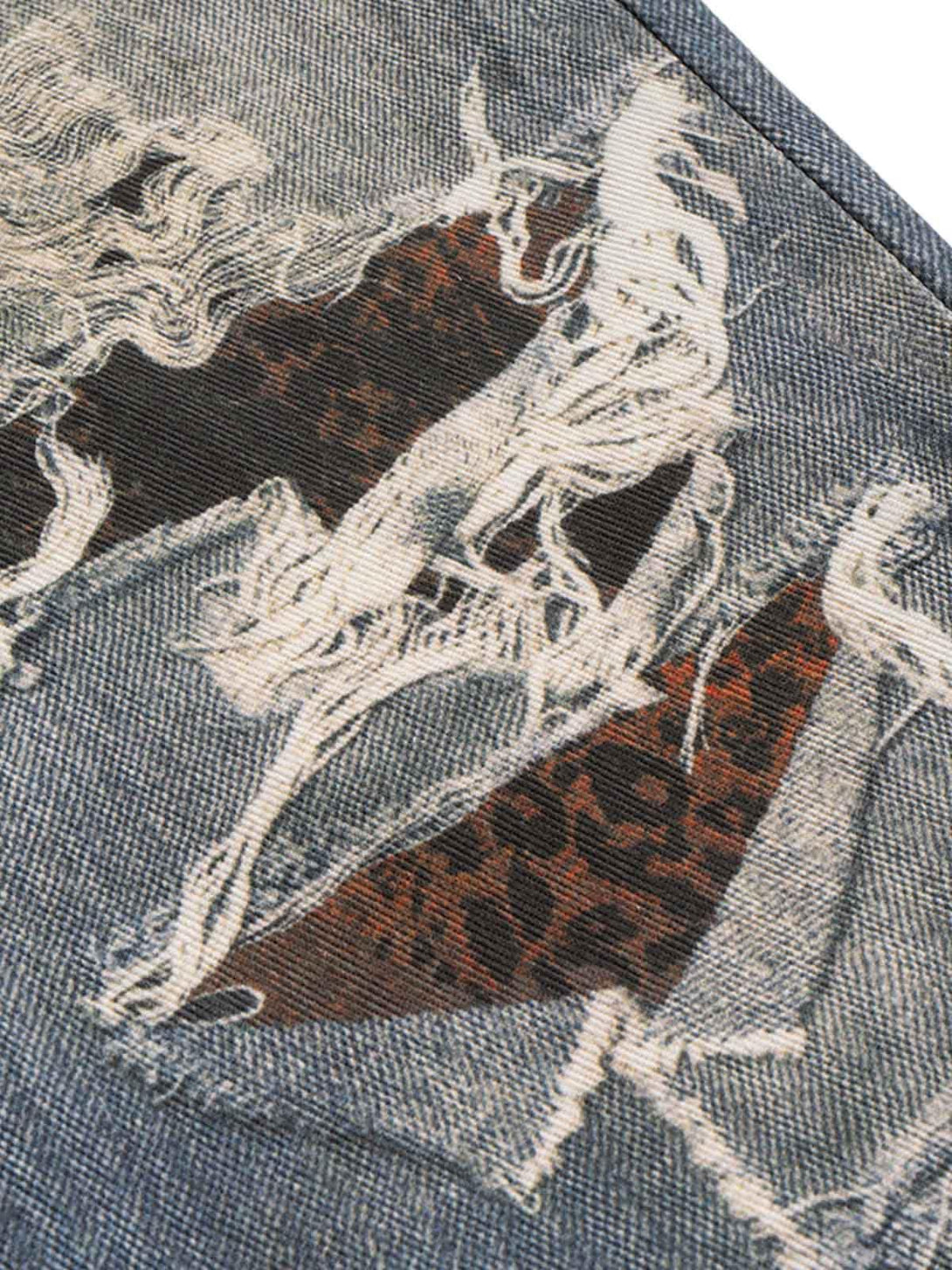 A close-up of TALISHKO's retro washed flare jeans, featuring intricate distressed patterns.
