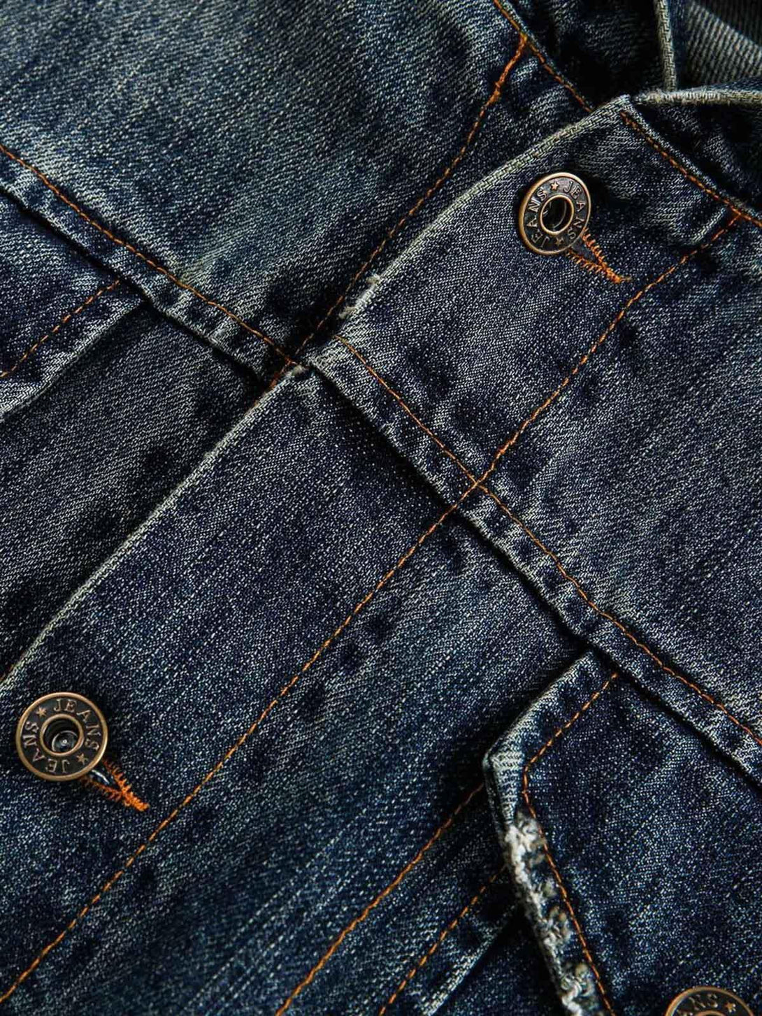 Detailed fabric and stitching on TALISHKO's retro washed workwear denim jacket.