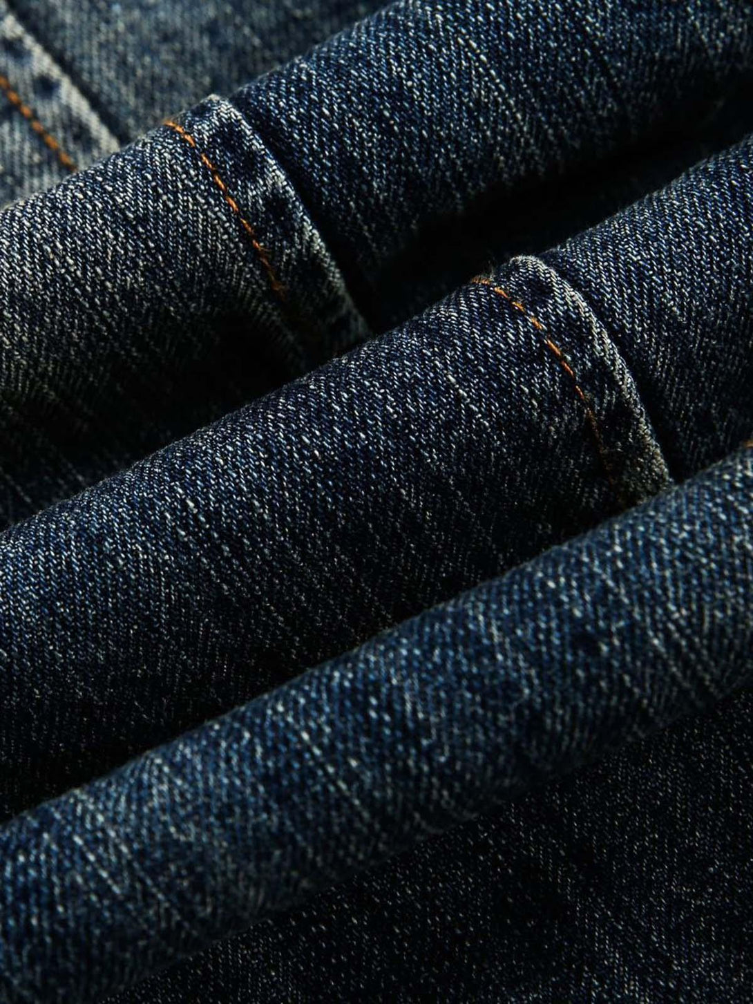 Focusing on the rich texture and stitching of TALISHKO's retro washed denim fabric.