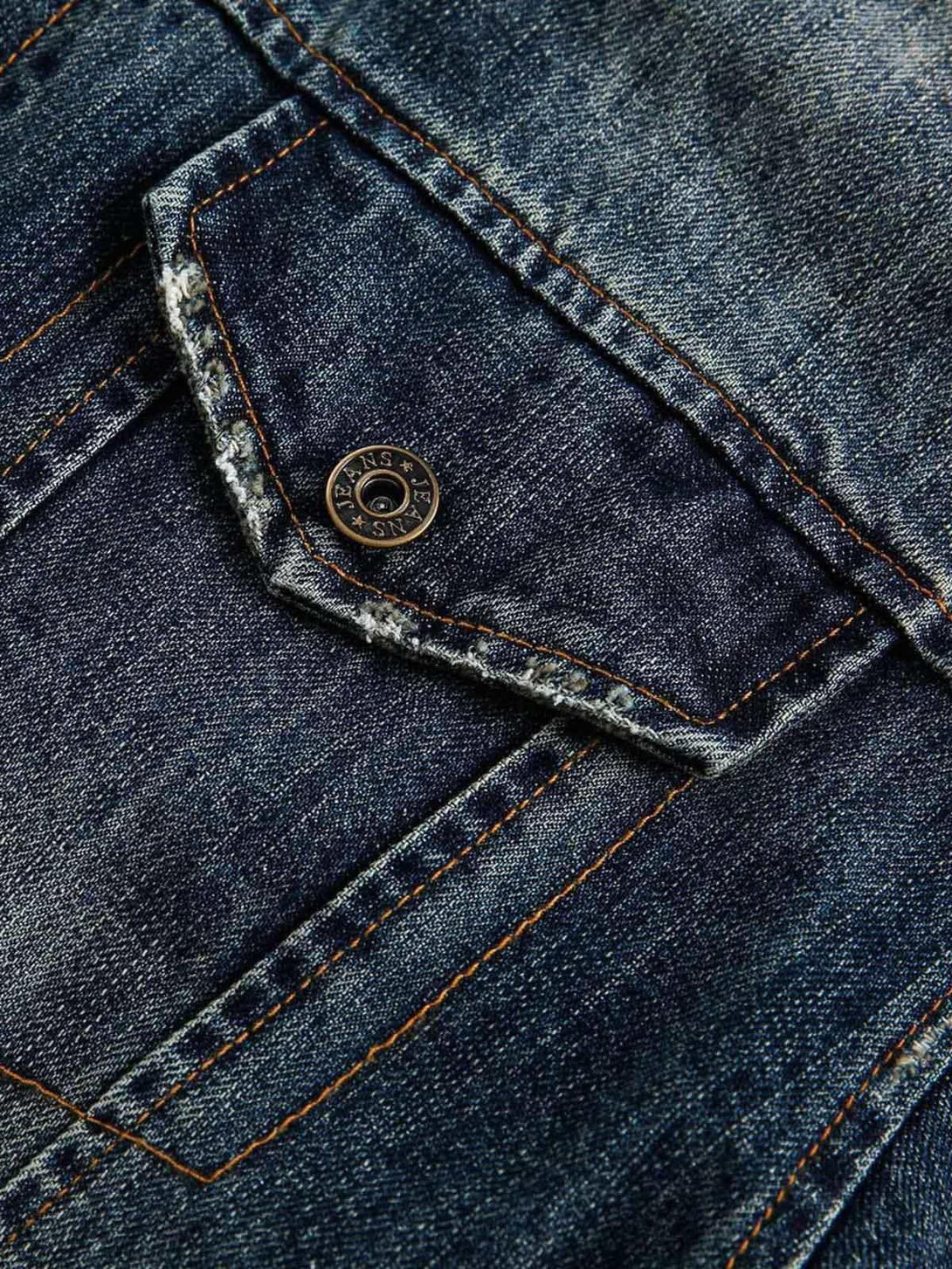 Intricate look at the pocket and button detail on TALISHKO's retro washed denim jacket.