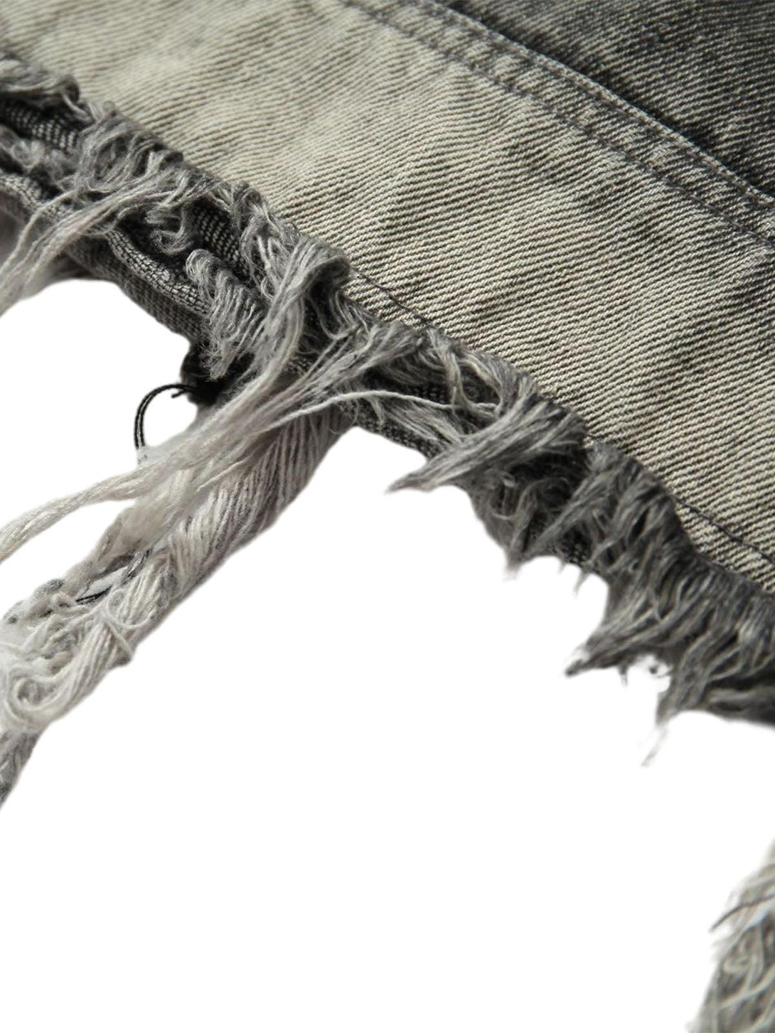 Detailed frayed hem of TALISHKO's retro denim vest, showcasing its rugged texture.