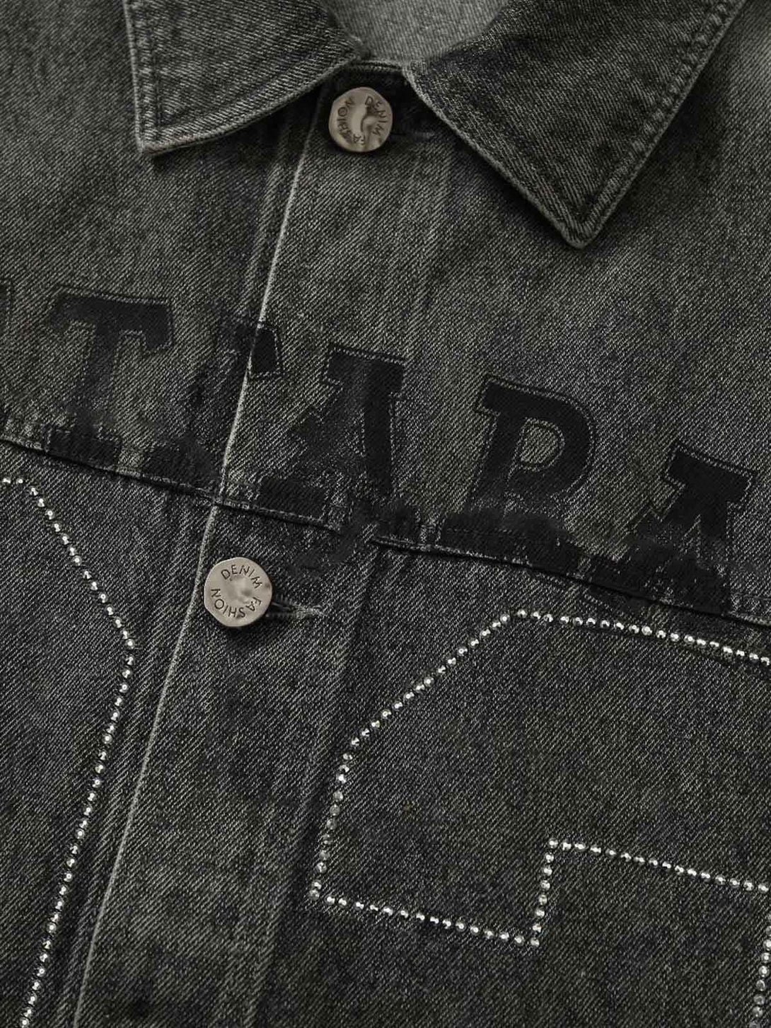 Intricate look at TALISHKO's denim vest, focusing on rivet details and bold lettering.