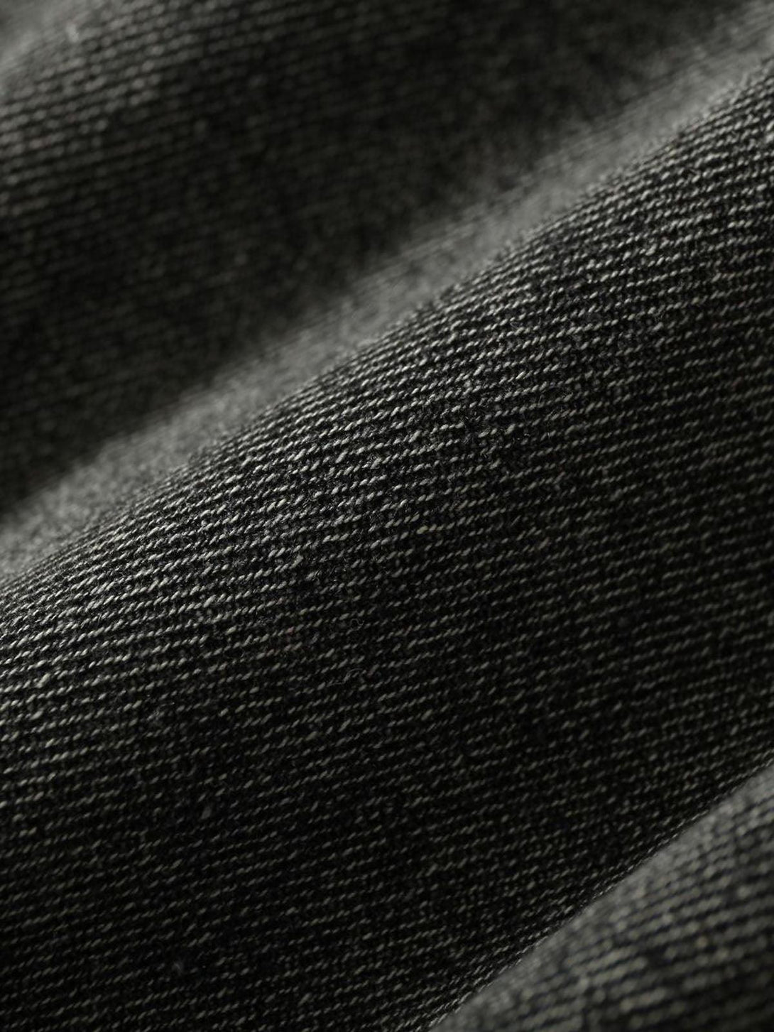 Texture and pattern showcased on TALISHKO's retro denim vest, highlighting rugged detail.