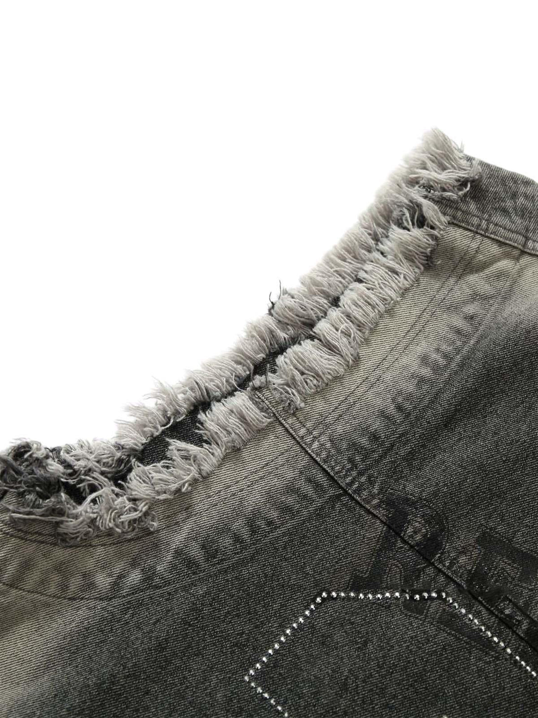 Focusing on the frayed neckline of TALISHKO's denim vest, highlighting its rugged style.