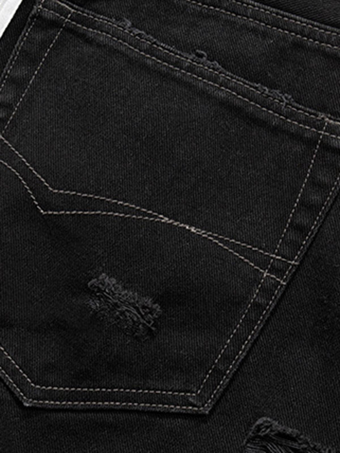 A close-up of TALISHKO black denim shorts highlights intricate stitching and retro raw edges.