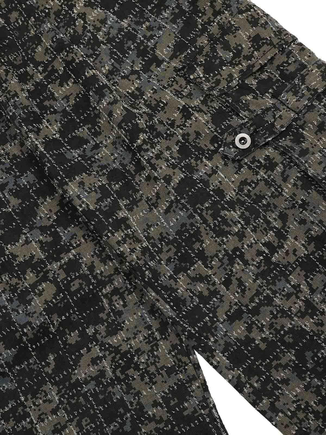 Detailed fabric and stitching of TALISHKO's camouflage cargo pants, highlighting the pocket design.