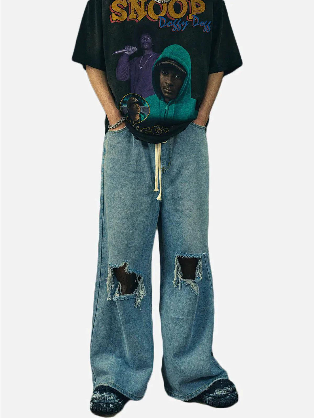 Model wearing TALISHKO ripped denim wide-leg pants, showcasing distressed urban style.