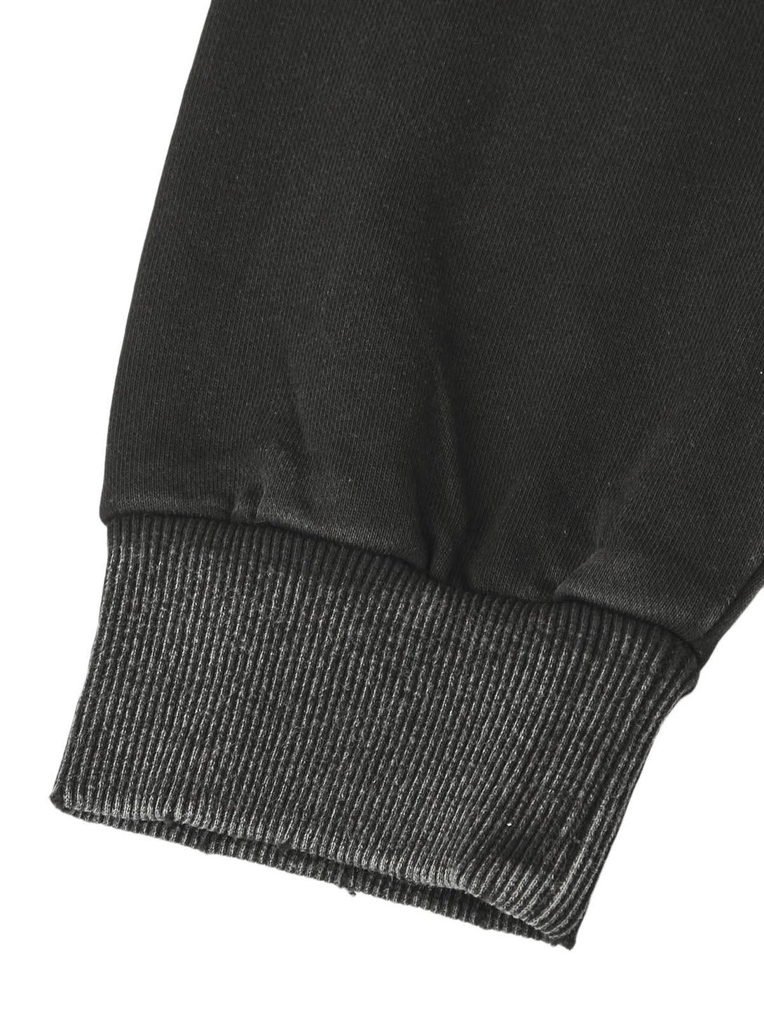 Ribbed cuff detail on a black zip-up jacket by TALISHKO, showcasing texture and style.