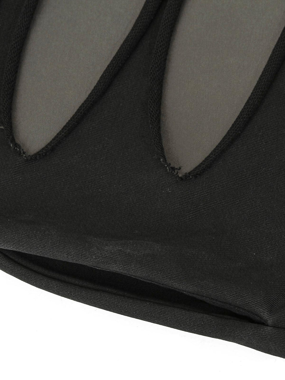 Detailed look at black zip-up jacket's cut-out design by TALISHKO, highlighting unique style.