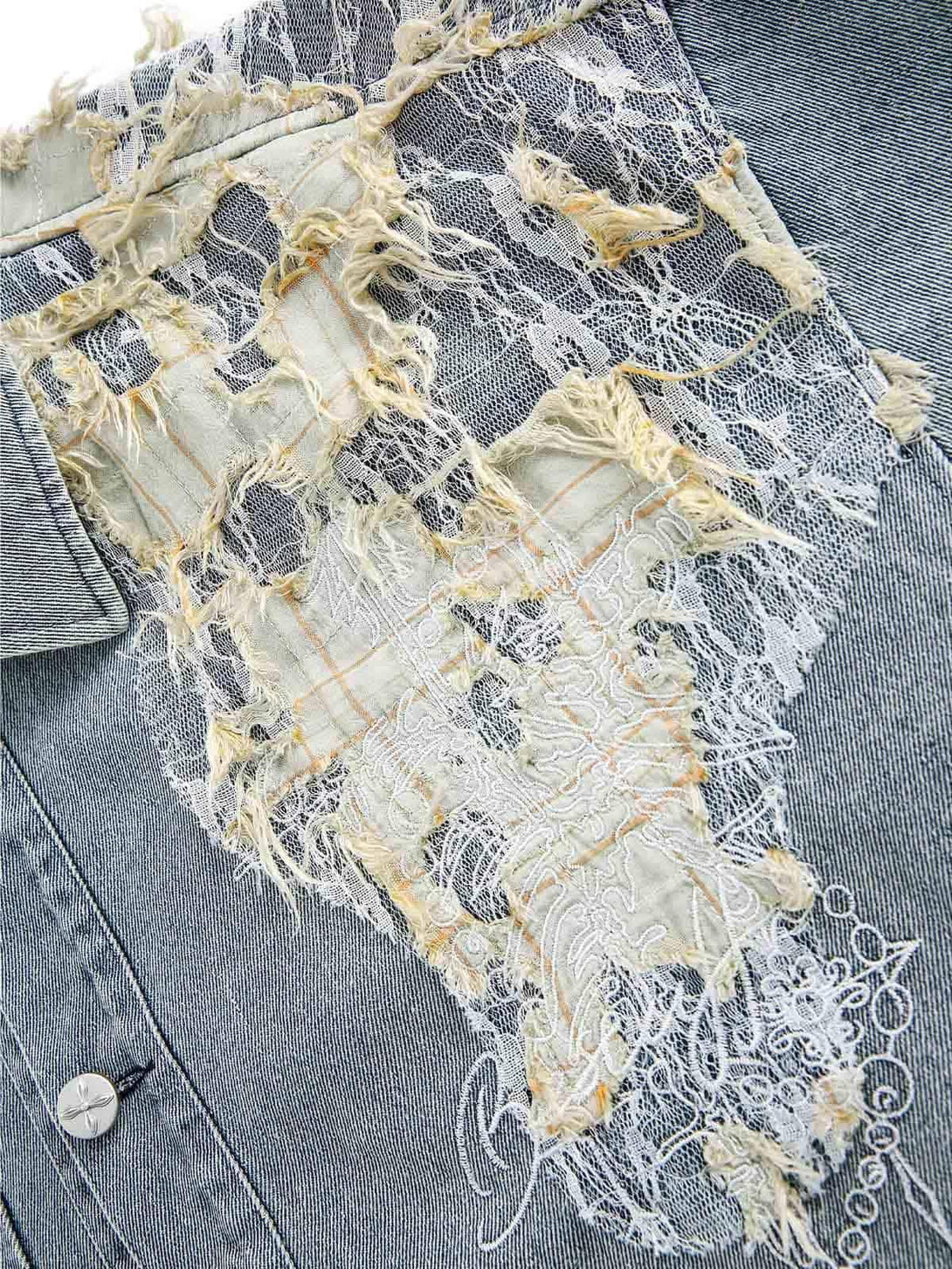 Intricate lace and distressed fabric detail on a TALISHKO denim jacket, showcasing unique texture.