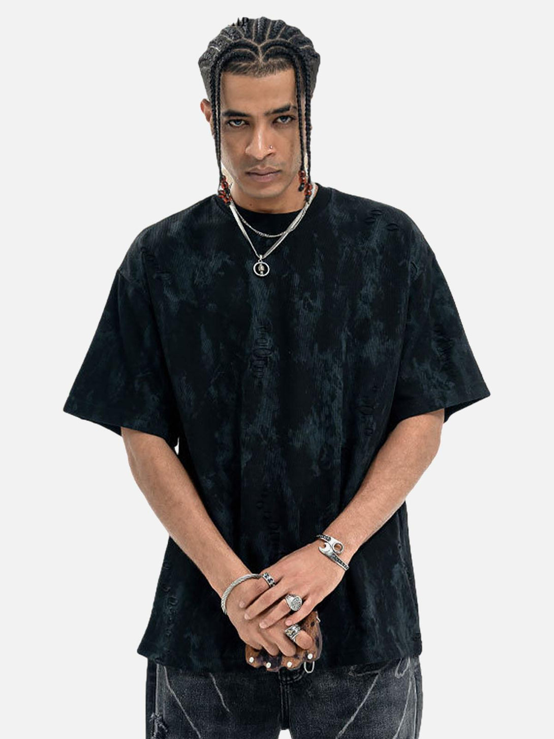 Model in TALISHKO's black ripped tie-dye T-shirt, styled with distinctive accessories.