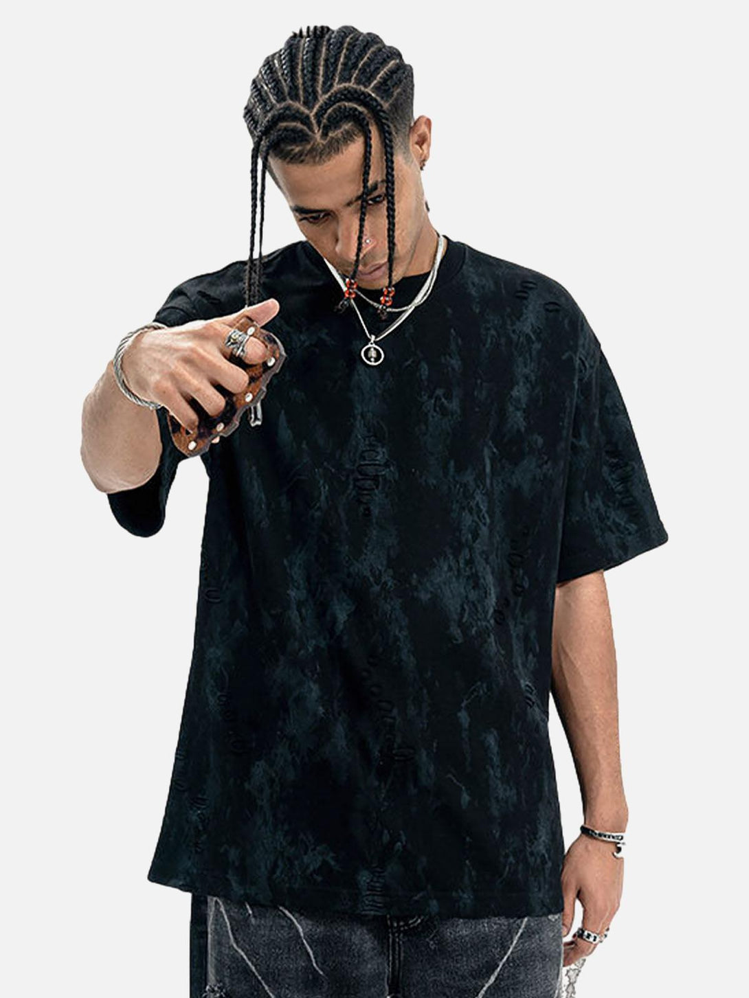 Model in black TALISHKO ripped tie-dye T-shirt, styled with accessories for a bold look.