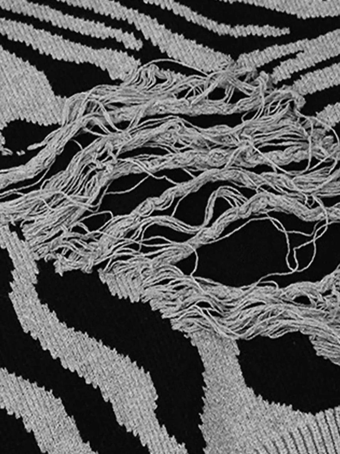 Zoomed-in texture of the ripped zebra pattern sweater by TALISHKO, highlighting intricate design.