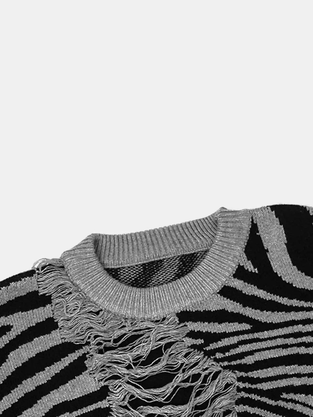 Intricate look at TALISHKO's zebra-pattern sweater, focusing on unique ripped texture details.