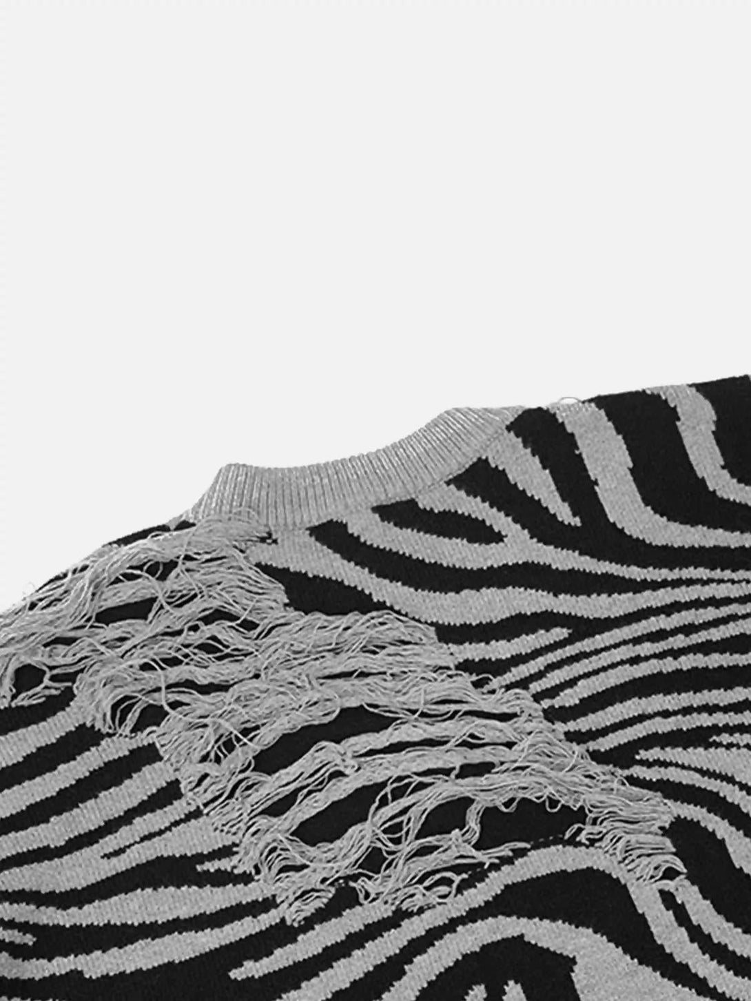 A close-up of the TALISHKO sweater, highlighting the ripped zebra pattern texture.
