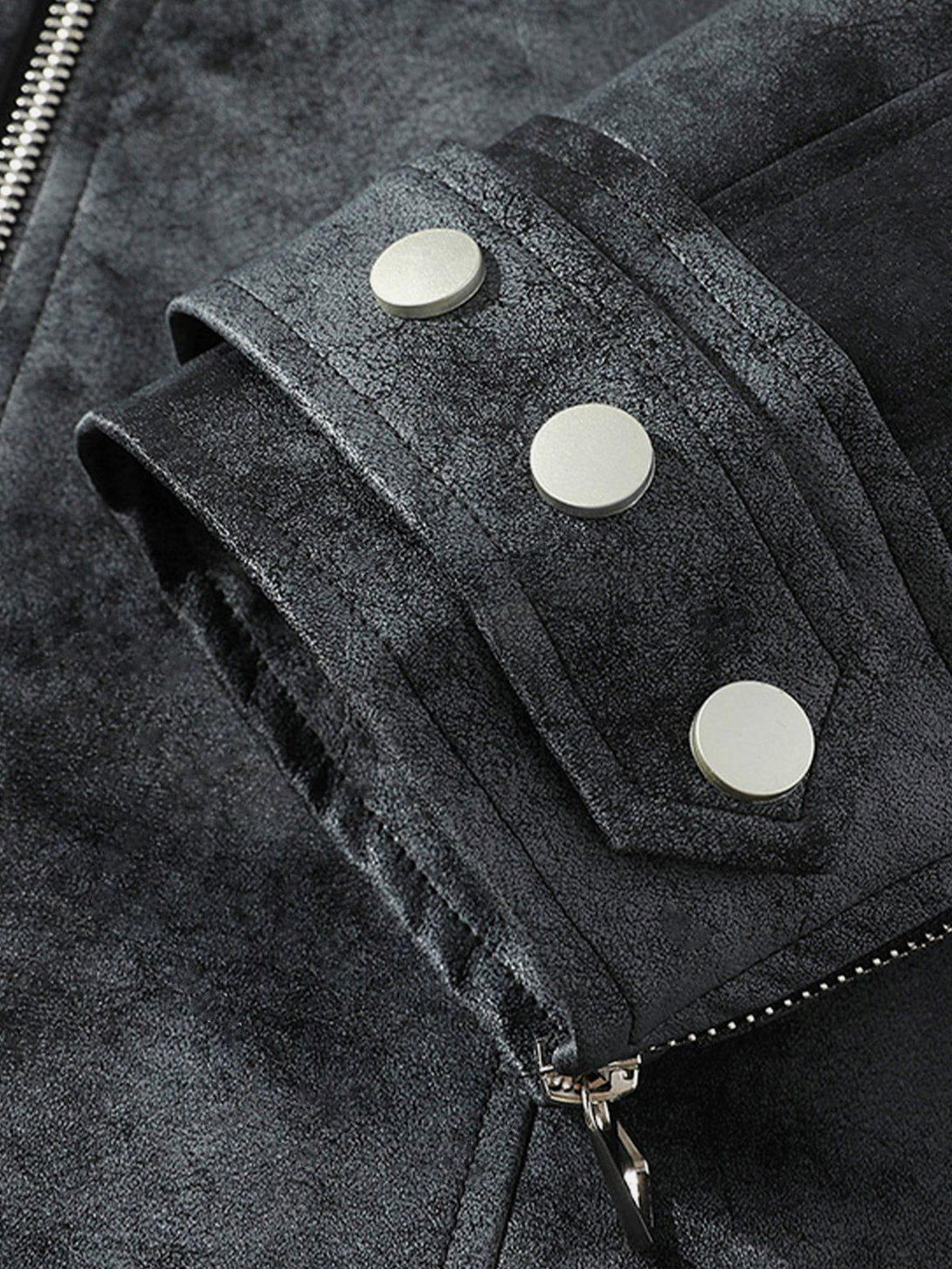 Detailed look at TALISHKO jacket's rivet and zipper accents, showcasing its sleek texture.