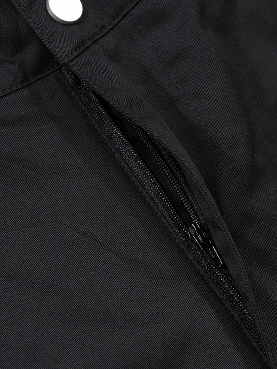 A detailed look at TALISHKO cargo pants highlighting the sleek zipper and fabric texture.