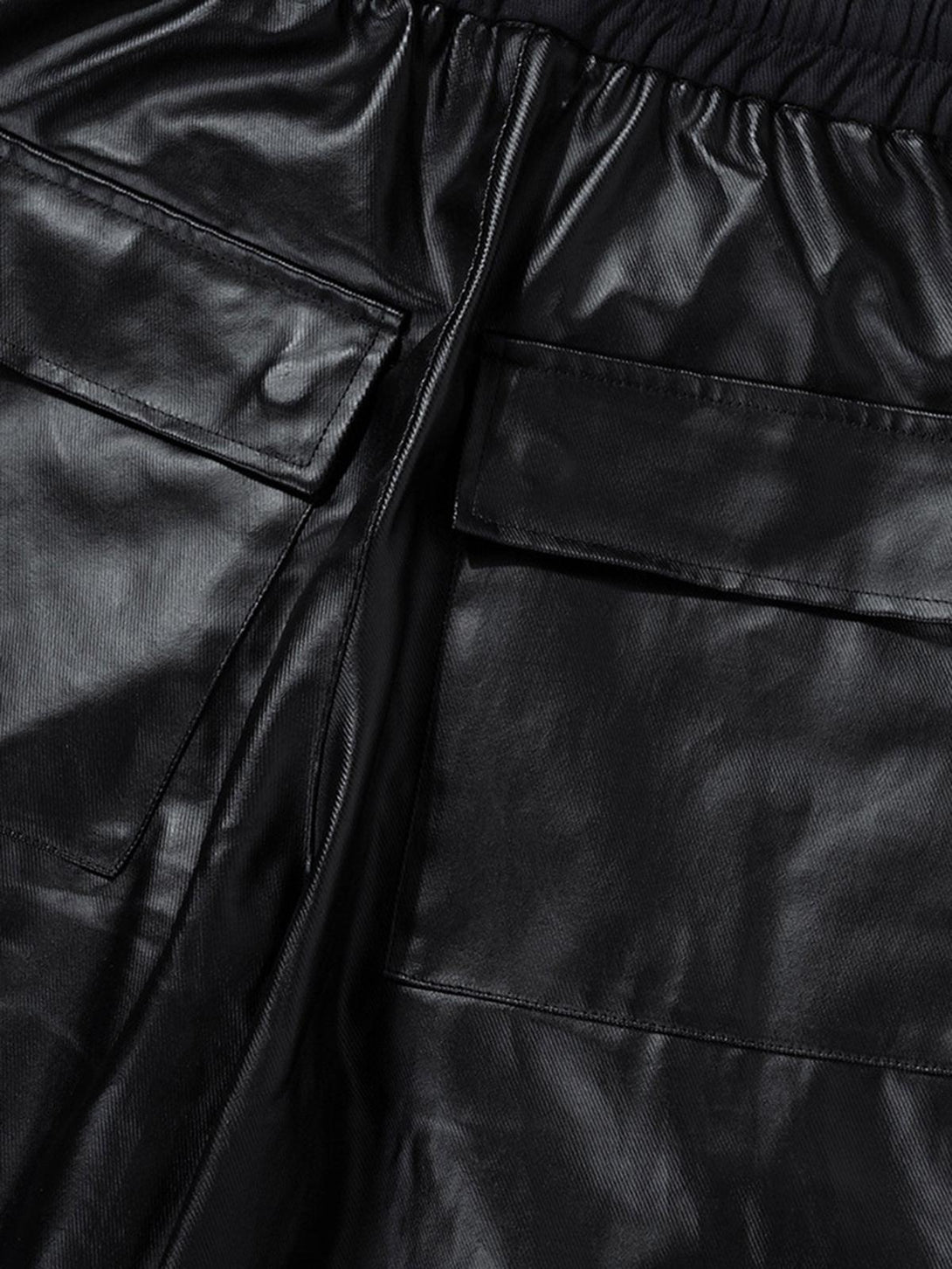 A close-up of TALISHKO matte coated overalls highlighting the multi-pocket design and texture.
