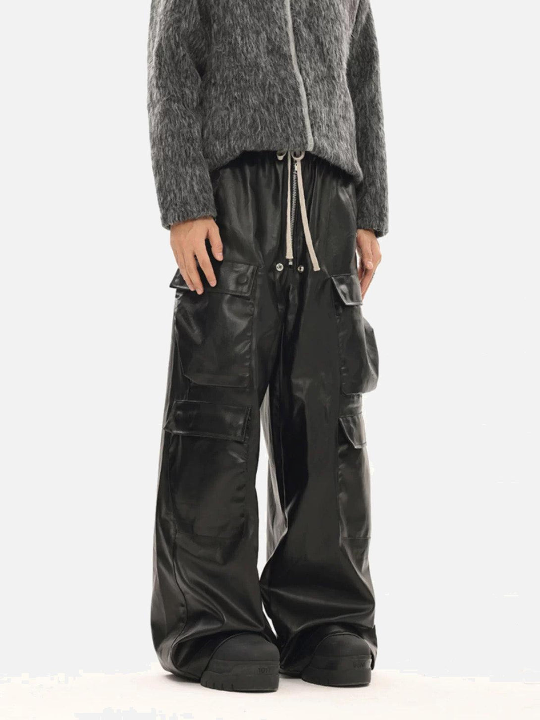 Model wearing TALISHKO black matte coated overalls with multiple pockets, adding a modern edge.
