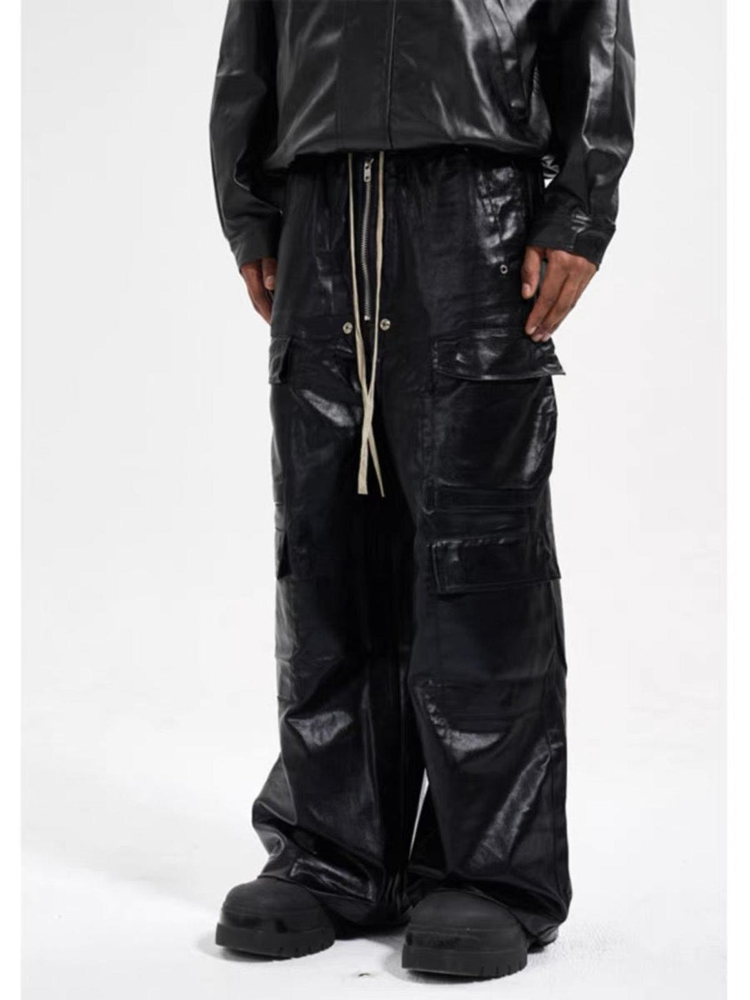 Model wearing TALISHKO matte overalls with multi-pocket design, showcasing edgy streetwear.