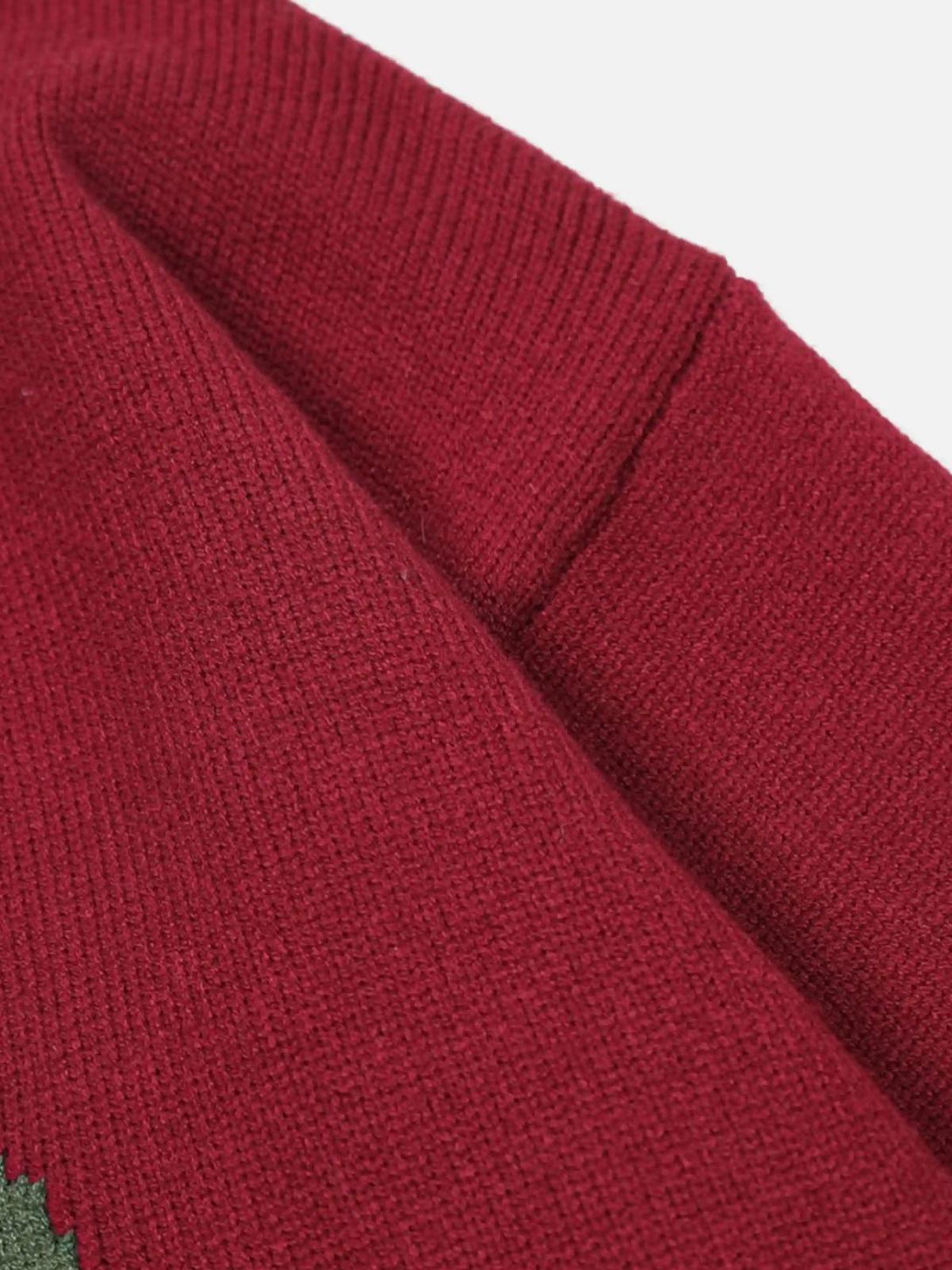 Detailed fabric and stitching of the red Santa crewneck sweater by TALISHKO.