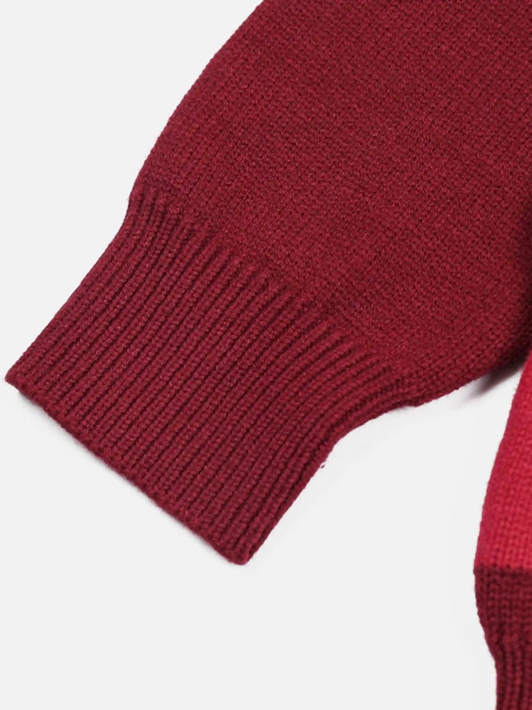 A detailed look at the ribbed cuff of the red Santa crewneck sweater by TALISHKO.