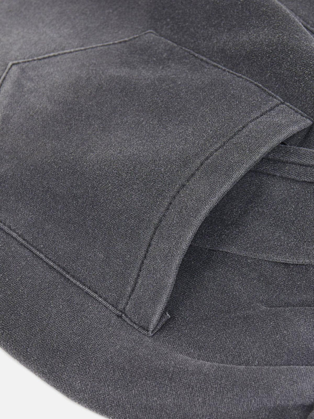 Detailed fabric and stitching of TALISHKO sweatpants, showcasing patchwork texture and design.