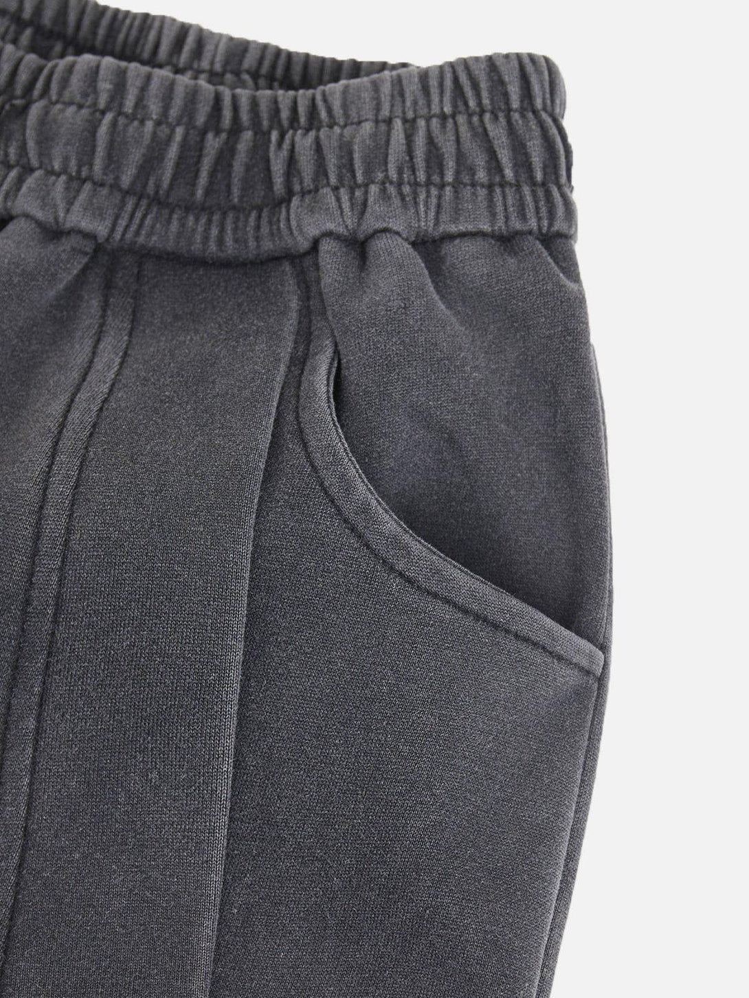 Detailed look at TALISHKO sweatpants' elastic waistband and pocket design, offering comfort.