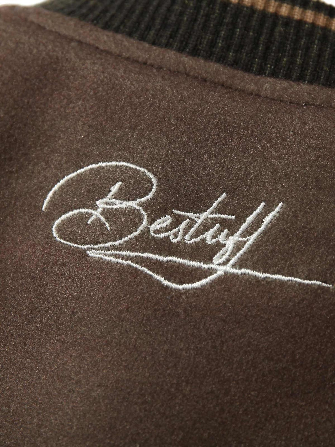 Intricate embroidery detail on TALISHKO bomber jacket, showcasing unique design texture.