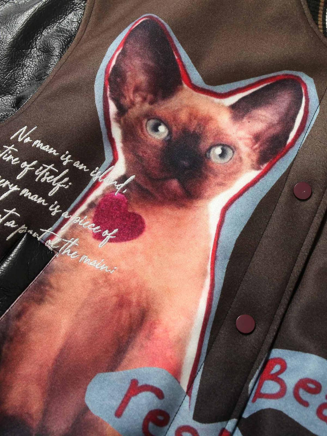 A detailed look at the Siamese cat embroidery on the TALISHKO leather bomber jacket.