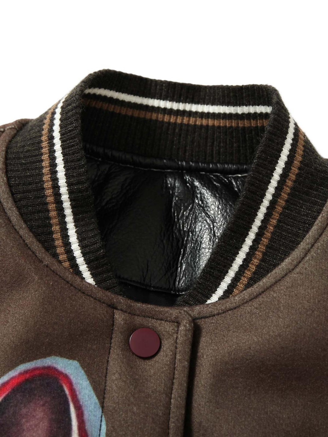 A detailed view of the TALISHKO bomber jacket's striped collar and button detail.
