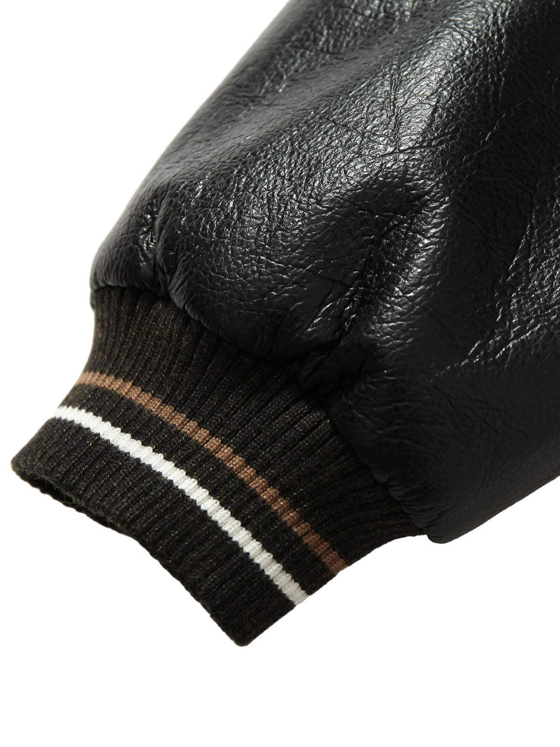 Detailed view of the TALISHKO bomber jacket's cuff, showcasing textured leather and ribbed trim.