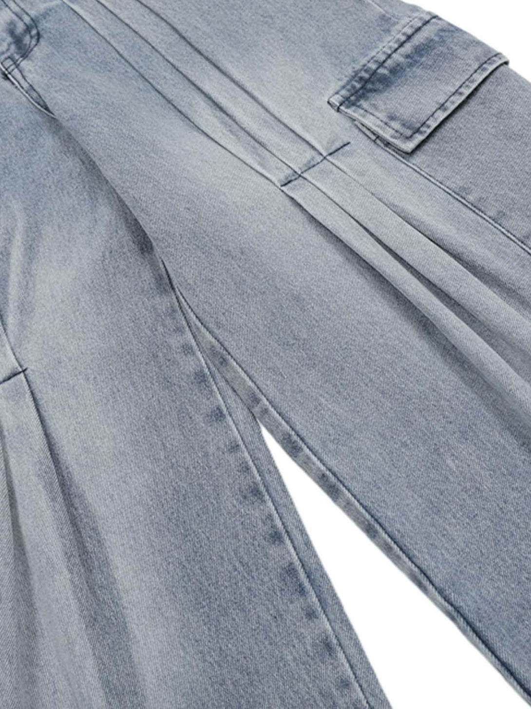 Intricate look at TALISHKO pleated baggy jeans with detailed side pocket and seam design.