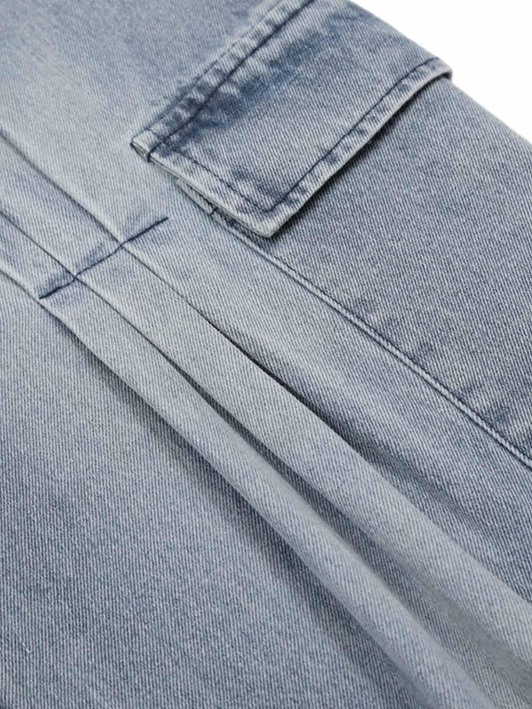 Detailed fabric and stitching of TALISHKO pleated baggy jeans with side pocket design.