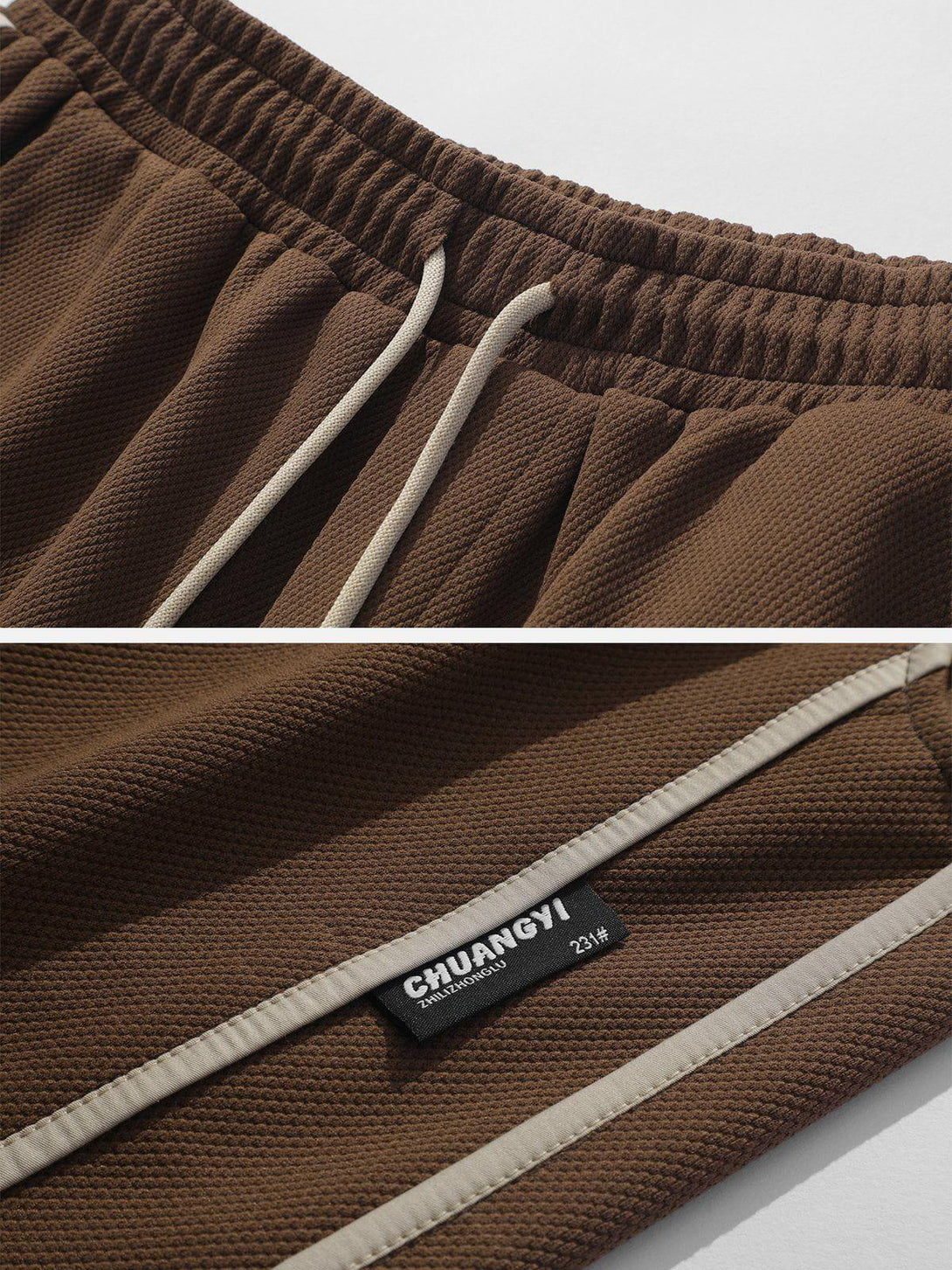 Detailed view of brown side stripe shorts by TALISHKO, highlighting elastic waistband and texture.