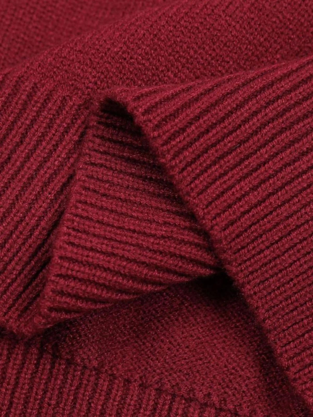 Zoomed-in texture of a red sweater by TALISHKO, highlighting its cozy knit detail.