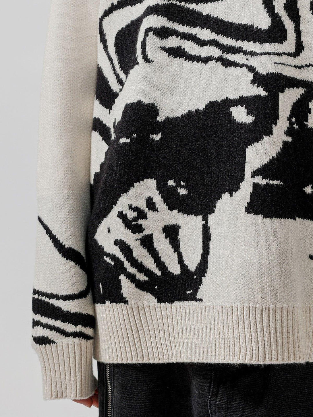 Intricate look at the skeleton portrait pattern on the TALISHKO sweater, showcasing bold contrasts.
