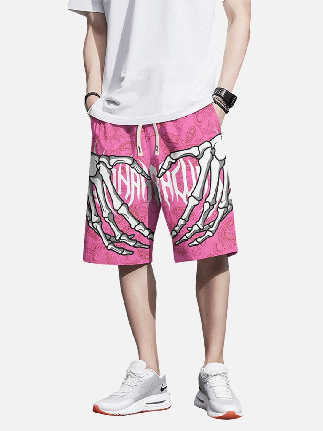 Model wearing pink hip-hop shorts by TALISHKO, featuring a bold skeleton hand design.