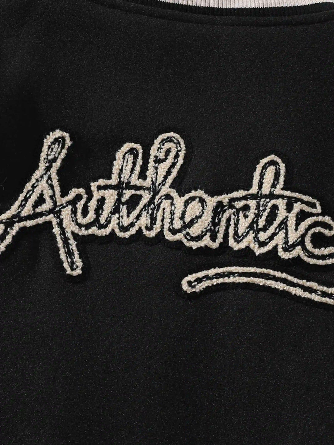 "Detailed embroidery of 'Authentic' on TALISHKO jacket, highlighting unique design detail."