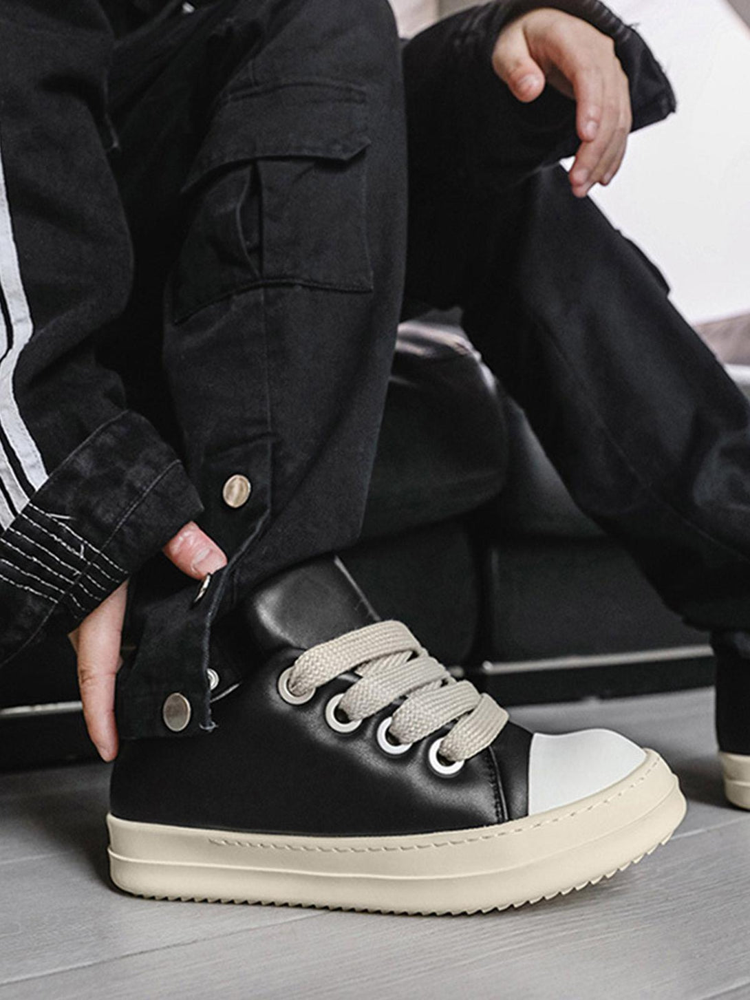 TALISHKO slip-on sneakers with black leather and cream soles, perfect for modern streetwear.