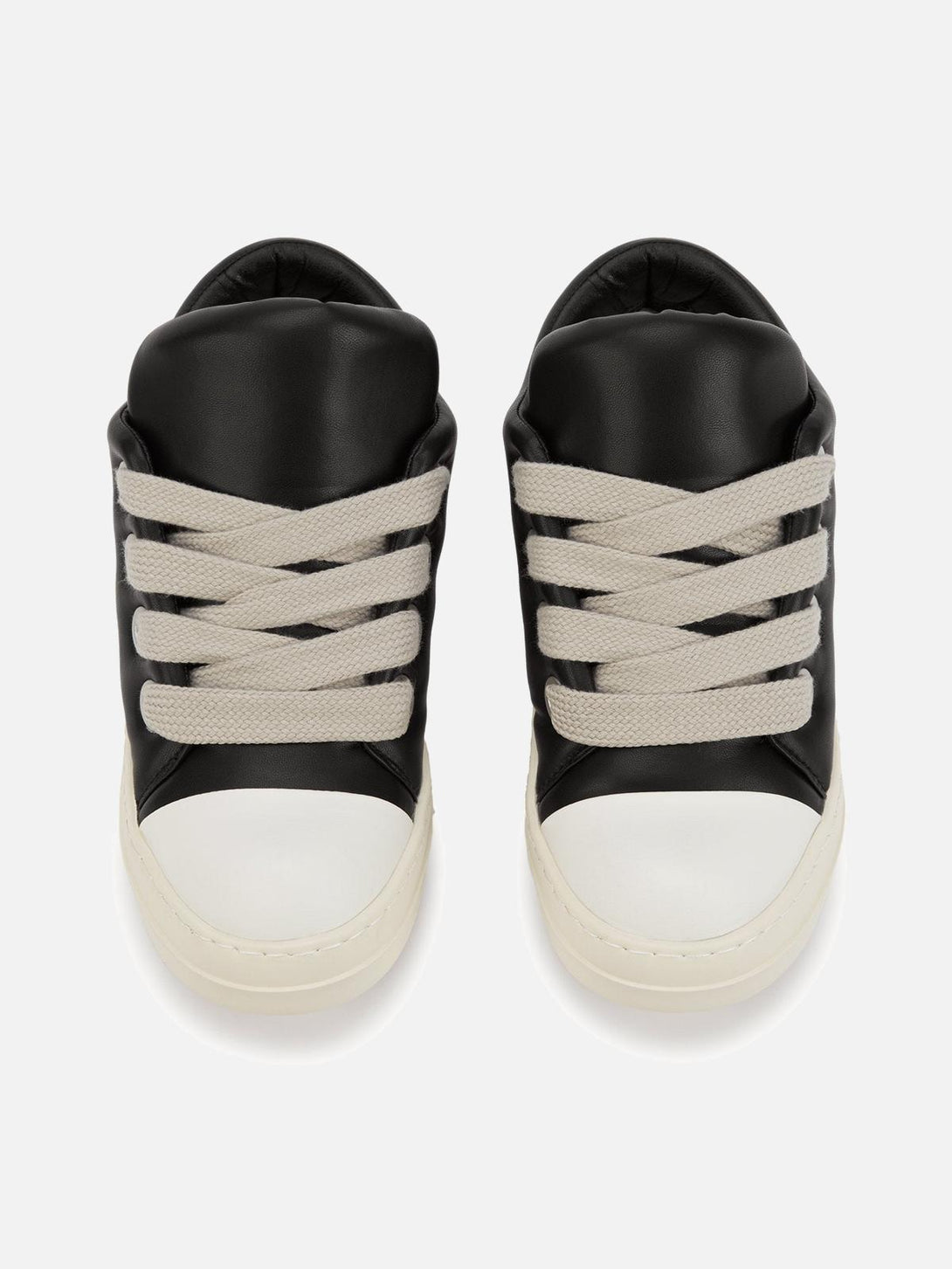 TALISHKO slip-on sneakers with wide laces and a sleek black and white design, ideal for urban wear.