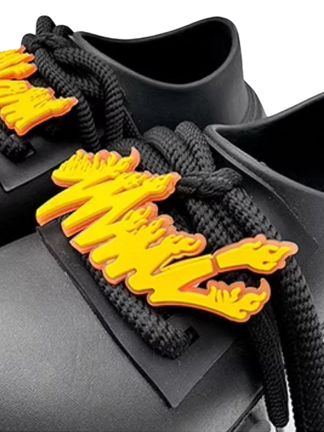 A close-up of TALISHKO slip-on derby platform shoes with striking orange lace accents.