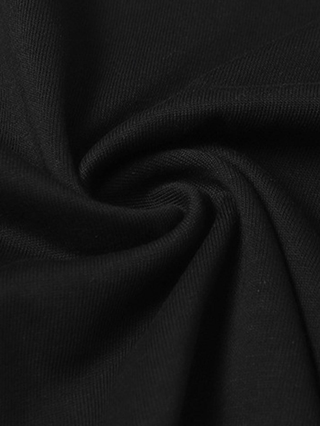 A close-up view of black fabric texture from a TALISHKO slogan graphic T-shirt.